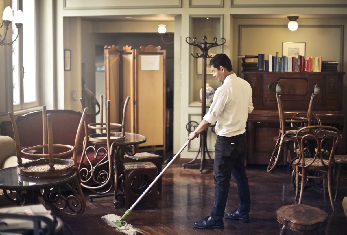 Housekeeping staff cleaning a floor